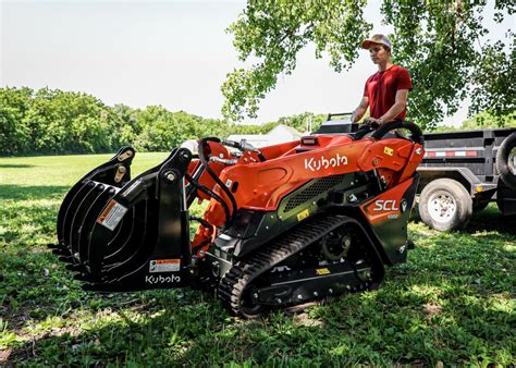 kubota skid steer with attchams on a trailer|land pride attachments for kubota.